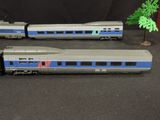 two toy trains sitting next to each other on a table
