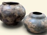 two vases sitting next to each other on a table
