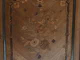 a wooden cabinet with a floral design on it