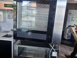a kitchen with a stove, oven, sink, and refrigerator