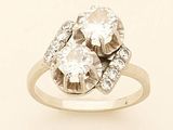 an image of a three stone diamond ring on a white background