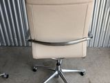 an image of a chair that is sitting in front of a metal wall