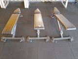four benches in the middle of a gym room