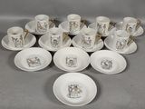 several cups and saucers are arranged on a table with spoons