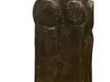 statue of a man and a woman on a stone base