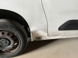 a white car with a flat tire on the street