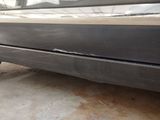 a close up of a car ' s bumper with the door open