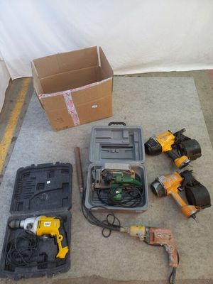 many tools that are sitting on the floor next to a box