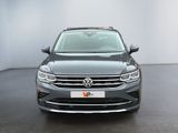 the front of a grey volkswagen vw parked in a white room