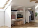 a closet with clothes and clothes on it in a room