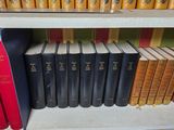 many books that are on a shelf in a library