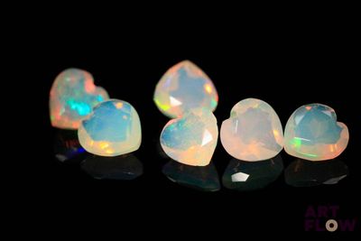 a group of white oplites sitting on top of a black surface