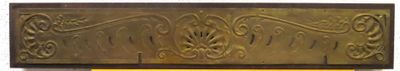 a picture of a gold plaque on a white wall