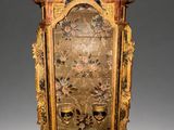 an antique wooden clock with gold and black paint on it