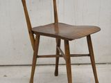 a wooden chair that has a wooden seat on it