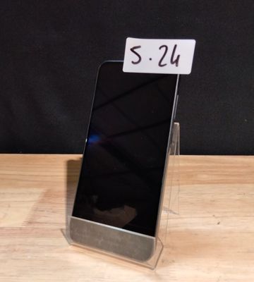 a cell phone that is sitting on a wooden table