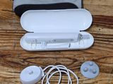 a bag with ear buds and a remote on a wooden table