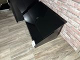 a black television sitting on top of a wooden floor
