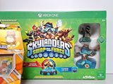 a box of skylas and a game controller next to each other
