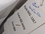 a tag with a name attached to a white bag