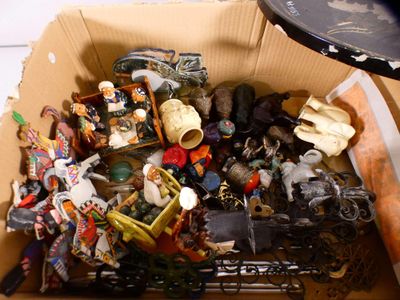 a cardboard box filled with assorted toys and figurines