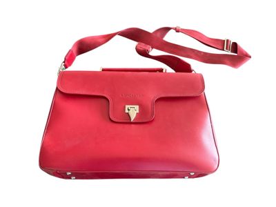 un sac à main en cuir rouge muni d'un fermoir métallique, sur fond blanc