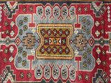 an image of a red, blue, and green rug with a design on it
