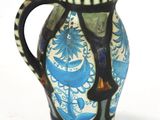a blue and white vase sitting on a white surface
