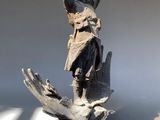 a statue of a man holding a bird in his hand