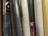 many rolls of wrapping paper in a cardboard box