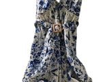 a blue and white dress hanging on a hanger