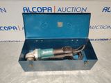 an electric tool in a blue box sitting on a table