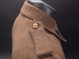 the back of a brown coat with buttons on a mannequin