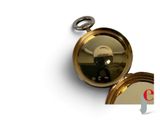 a gold pocket watch with a black face on it