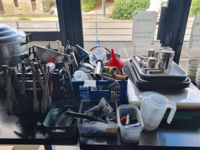 a table with a bunch of kitchen utensils on it