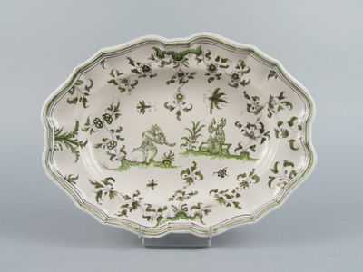 an image of a green and white plate with a design on it