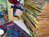 several comics are stacked on top of each other on a table