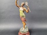 an image of a statue of a woman holding a flower