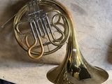 a brass french horn sitting on top of a table