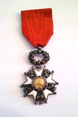 an image of a medal with a red ribbon on a white surface