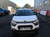the front of a white car parked in a parking lot