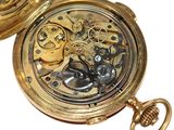 a gold pocket watch with a chain attached to it