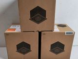three boxes of speakers stacked on top of each other on a table