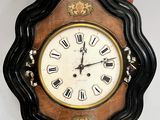 a clock on the wall with roman numerals on it