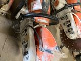 several chainsaws are sitting on the floor next to each other