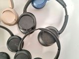 several headphones sitting on top of each other on a table