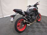 a picture of a motorcycle parked on a black and red checkered floor