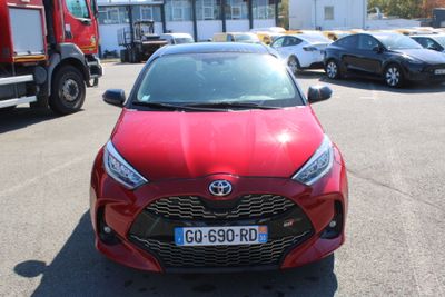 a red car that is parked in a parking lot