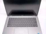 an open laptop computer sitting on top of a white table