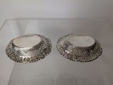 pair of silver plated bowls on display in a glass case